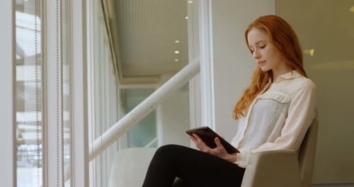 Female executive using digital tablet in office 4k