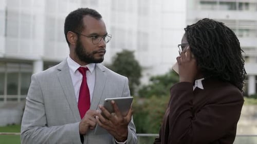 Business Professionals with Tablet and Phone Outside