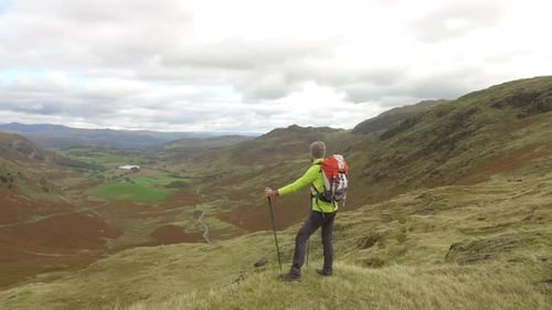 Hiker aerial view hiking in the hills