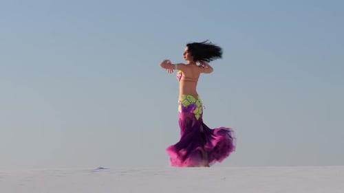 Beautiful Woman Belly Dancing in Desert Landscape