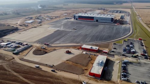 Aerial Drone Shot of New Constructions Development Site Warehouses Projects and Heavy Machinery and