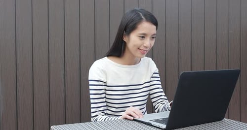 Woman with Laptop Reacts to Good News