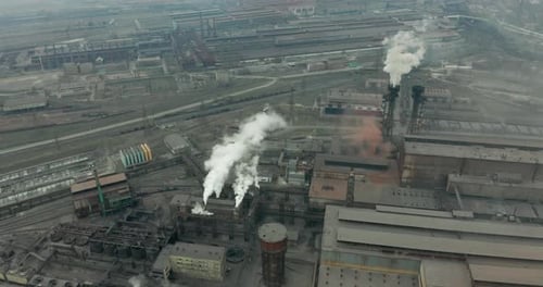 Epic Aerial of High Pipes with Smoke Emission. Plant Pipes Pollute Atmosphere. Industrial Factory