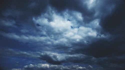 Dark Clouds Moving across Blue Sky