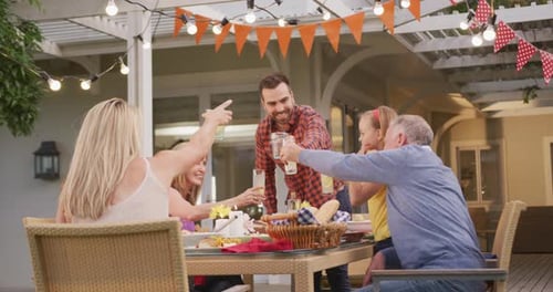Family Cheers at Outdoor Celebration on Suburban Patio