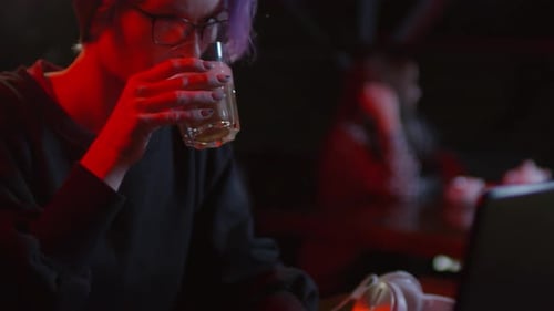 Female Hacker Sitting in Bar