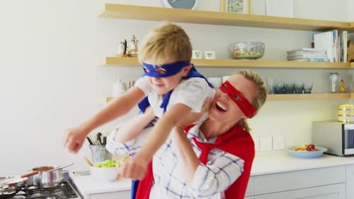 Woman and Child Play Superhero in Kitchen