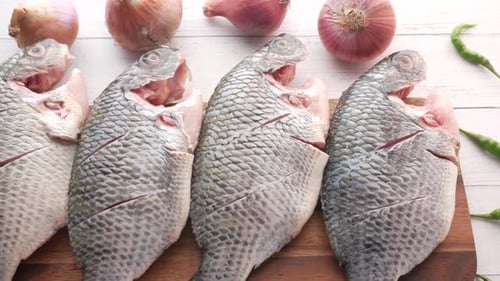 Raw Fresh Fish on a Chopping Board for Preparing for Cooking on Table