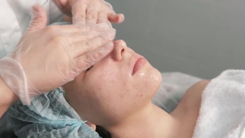 Woman Receives Facial Massage in Clinic Setting