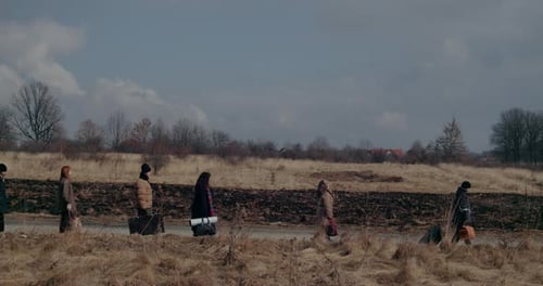 Ukrainian Refugees Walking On Road During War Crisis