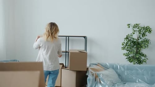 Young Couple Unpacking Boxes in New Home