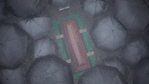 Overhead View of Rainy Funeral with Coffin and Umbrellas
