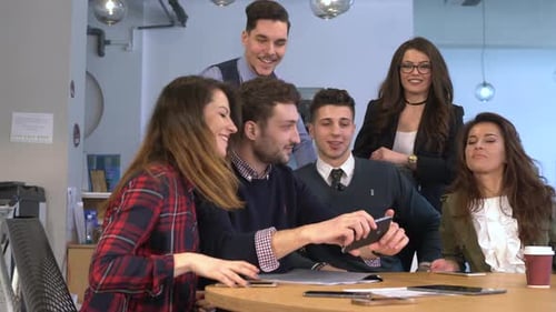Young people taking a selfie at the office