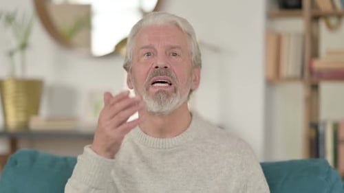 Senior Man Waving and Talking to Camera