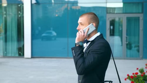 Handsome Businessman Talking on Phone Near Office. Young Business Man Speaking on Cellphone Outdoor