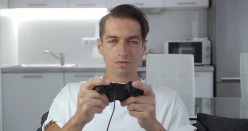 Upset man playing video game in his apartment