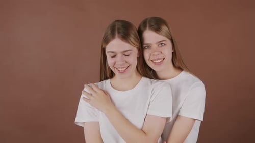 Portrait of Twin Sisters Posing Together