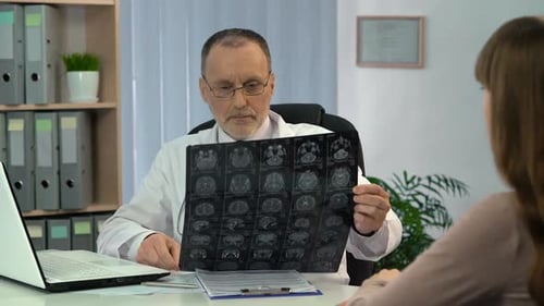 Doctor Examining Brain Scan with Patient in Office