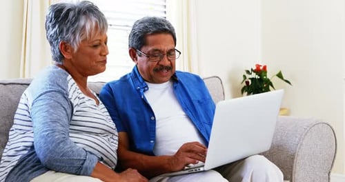 Senior Couple Uses Laptop Together at Home