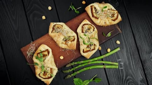 Savory Tarts with Asparagus, Hazelnuts on Wooden Table