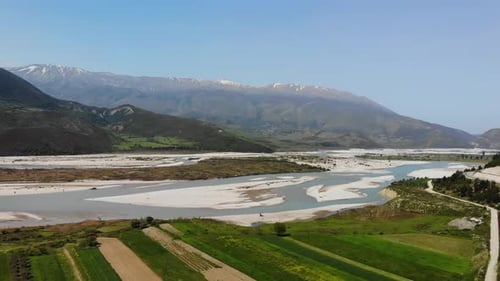 Aerial Drone Footage View Flight Over Mountain with Forests Fields and River in Sunrise Soft Light