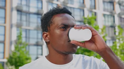Young Adult Drinking Outdoors on Sunny Day