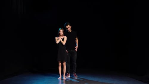 Romantic Choreography Against Black Background in Spotlight at Studio.
