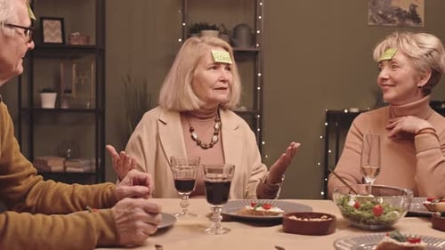 Seniors Play Guessing Game Together at Dinner