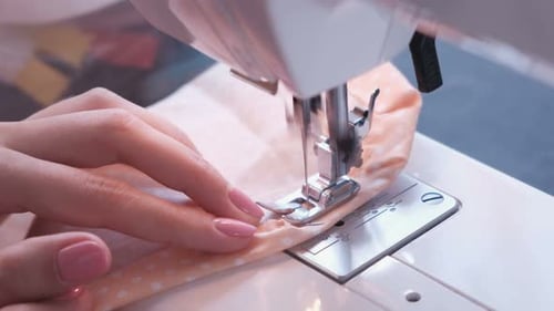 Woman Sewing Detail on the Sewing Machine. Close-up Hand.