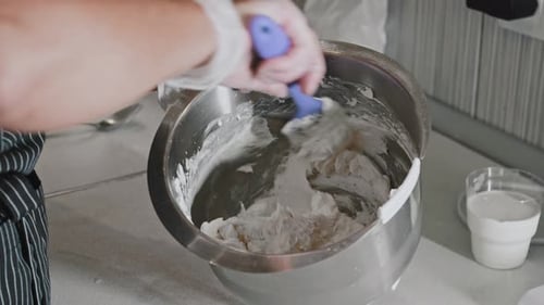 Chef Mixing Filling in Metal Bowl in Kitchen