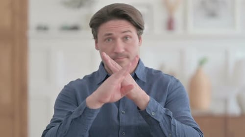 Man Showing a Negative Gesture Indoors