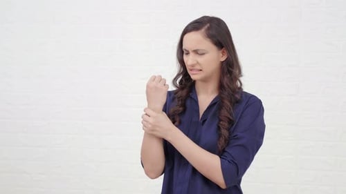 Woman Holding Her Sore Wrist in Pain