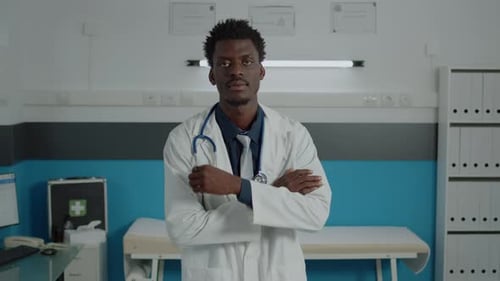Smiling Doctor Poses Confidently in Medical Clinic