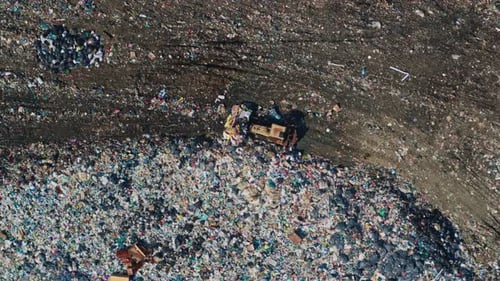View From Drone of Truck Ramming Garbage on Nature