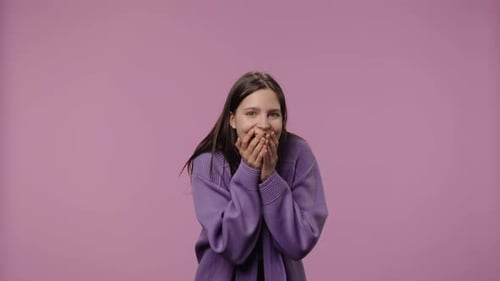 Woman reacts with joy and surprise indoors
