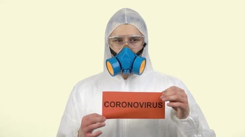 Person in Hazmat Suit Holding Coronavirus Sign