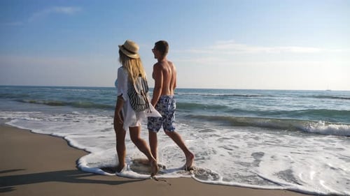 Couple of Lovers Walking at Coast and Holding Hands During Resting on Resort. Man Hugs Woman