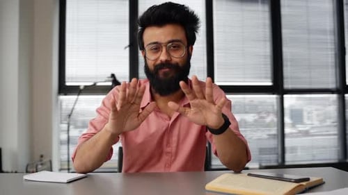 Webcam View of Handsome Positive Indian Businessman Talking with Colleagues on Video Call Using