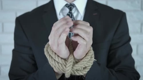 Man in Suit with Hands Bound in Rope