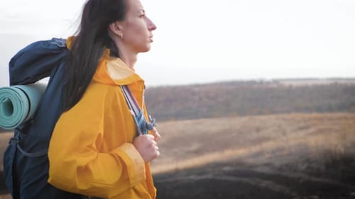 Woman Hiking with Backpack in Rural Landscape