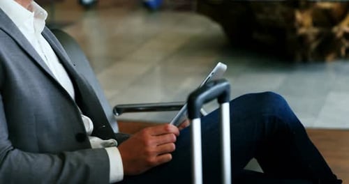 Adult Man Using Tablet in Modern Lobby