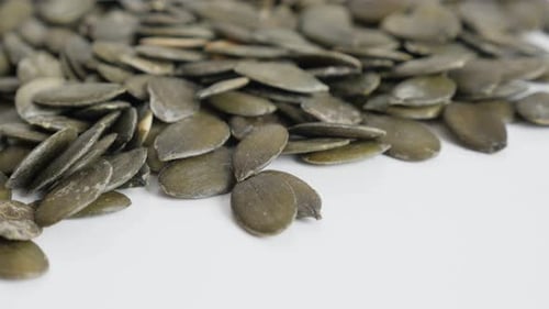 Pile of Green Pumpkin Seeds on White Surface