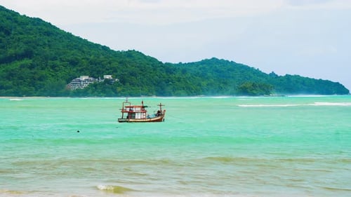 Fishing Boat in The Sea on The Waves, Tropical Island