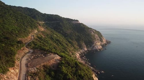 Aerial Footage of Beautiful Coastal Curvy Road on a Green Island
