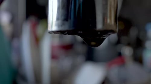 A leaky tap: water gathers on the tap's edge and forms a drop, then falls down.