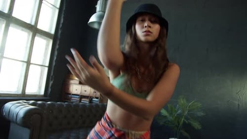 Stylish Woman Dances Hip-Hop in Urban Studio