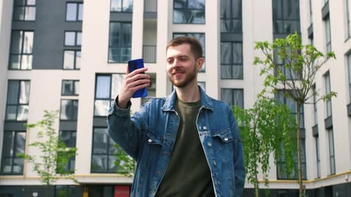 Young Adult Using Phone in Urban Courtyard