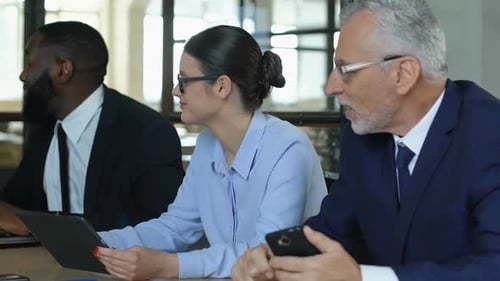 Business Meeting in Office with Tablet and Cellphone