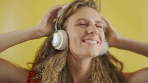 Woman with Headphones Dancing to Music
