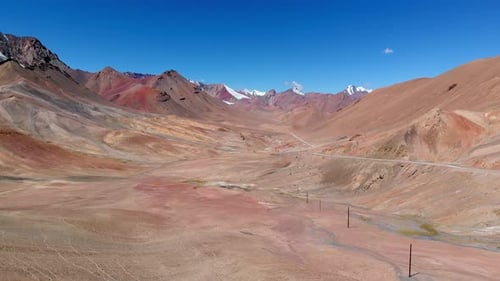 Drone View of Curved Road Crossing Hot Desert